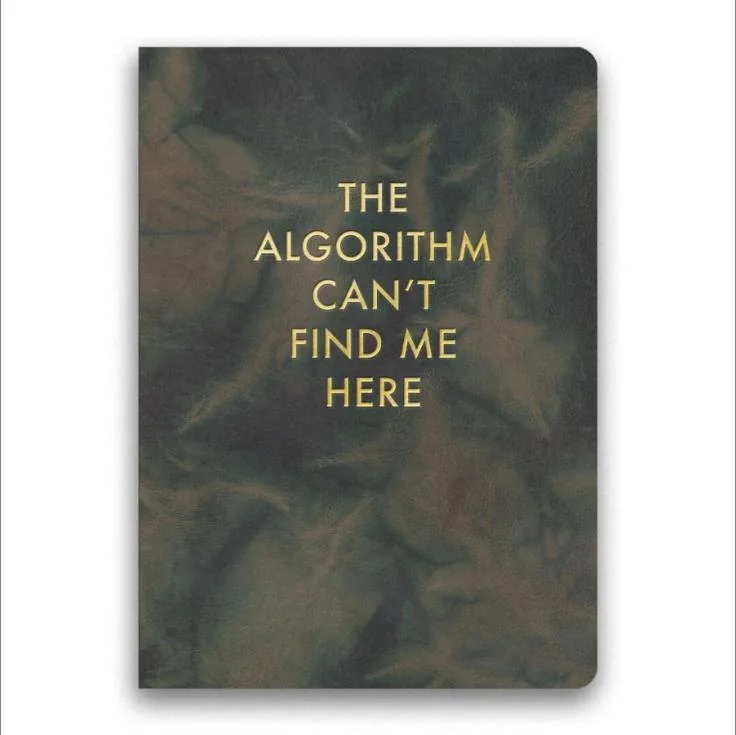 Dark green journal with gold foil reading The algorithm can't find me here