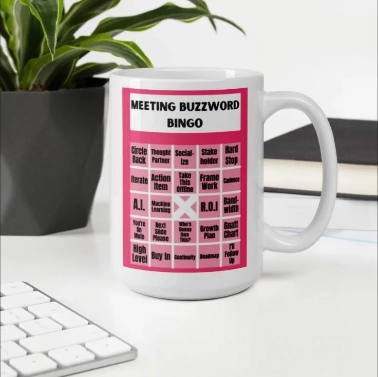 White mug printed with a Meeting Buzzword Bingo card