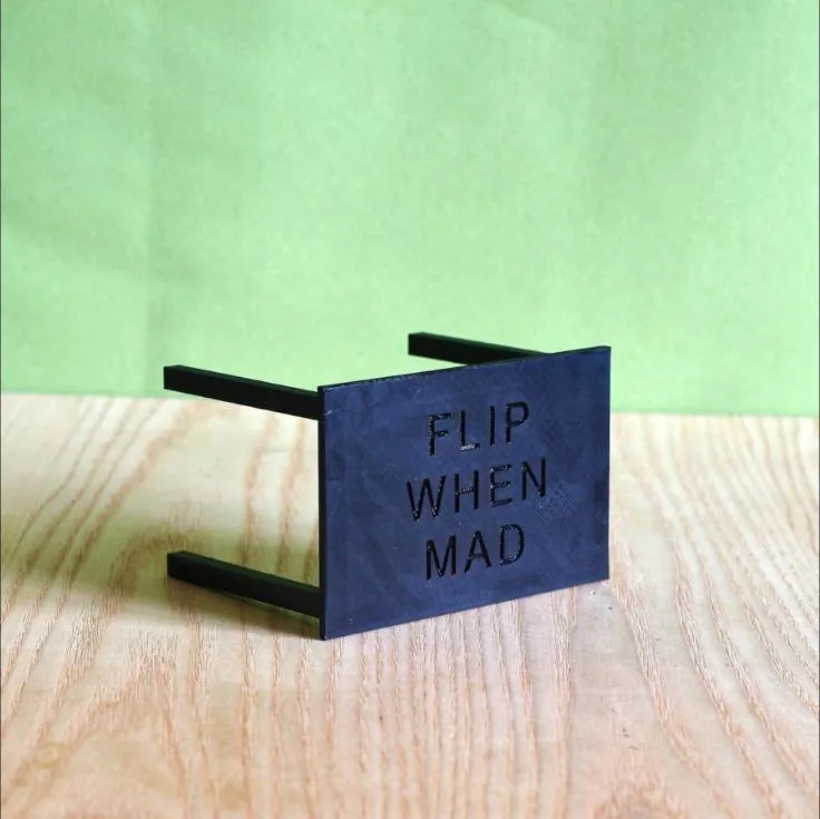 Tiny 3D-printed upside-down table reading Flip when mad