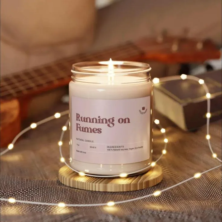 Soy candle in a glass jar labelled Running on Fumes