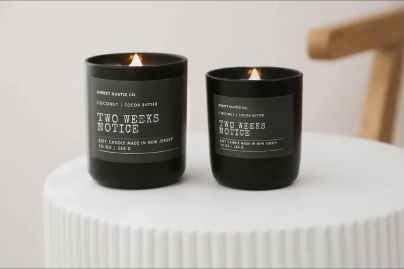 Two black candles labelled Two Weeks Notice